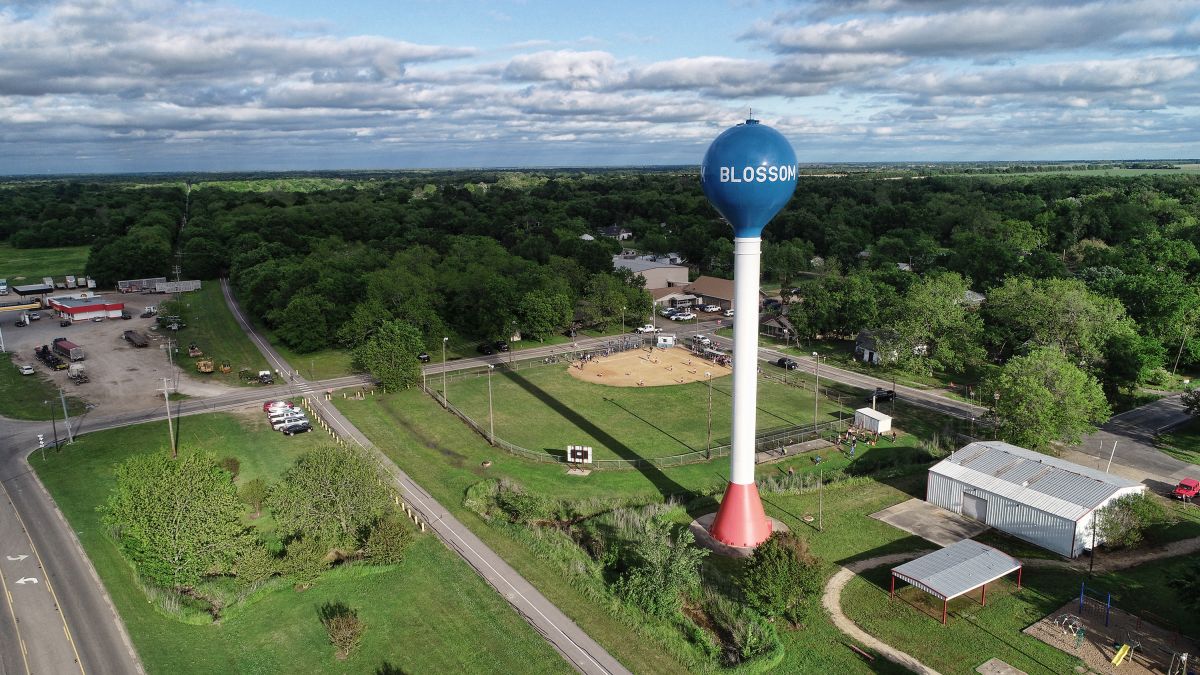 aerial view of water tower, softball field, and city park